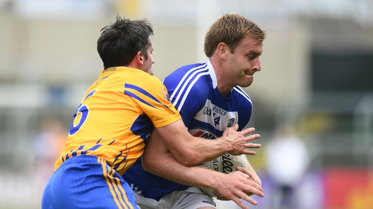 Laois' Donal Kingston is tackled by Gordon Kelly of Clare