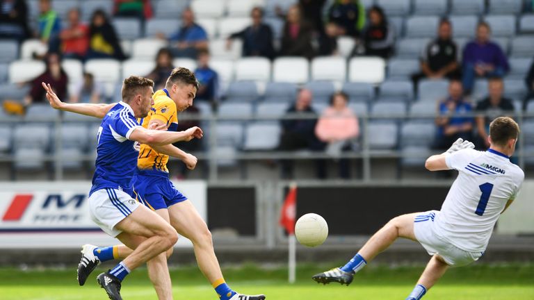 Clare's Jamie Malone shoots to score his side's first goal of the game despite the efforts of Laois duo Colm Begley, left, and Graham Brody