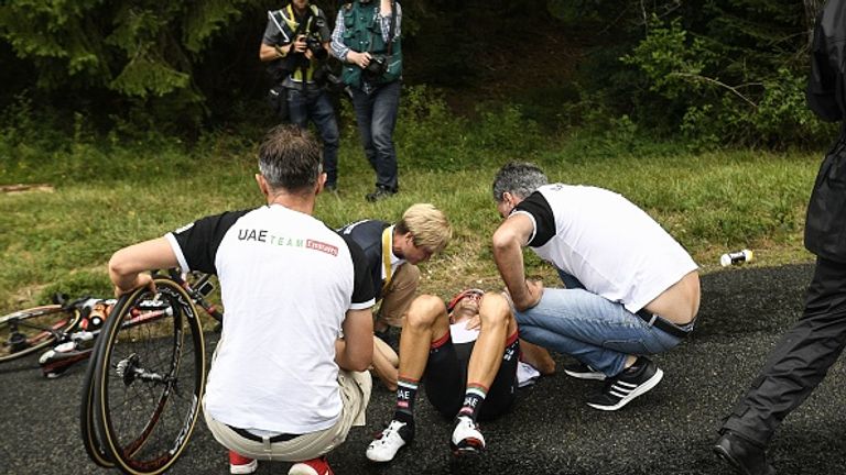 Manuele Mori receives medical assistance after falling early during the ninth stage of the Tour de France