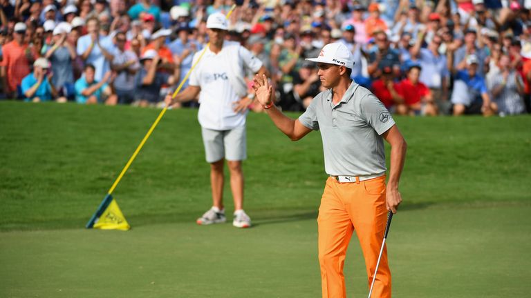 Rickie Fowler acknowledges the crowd after finishing his round on the 18th green