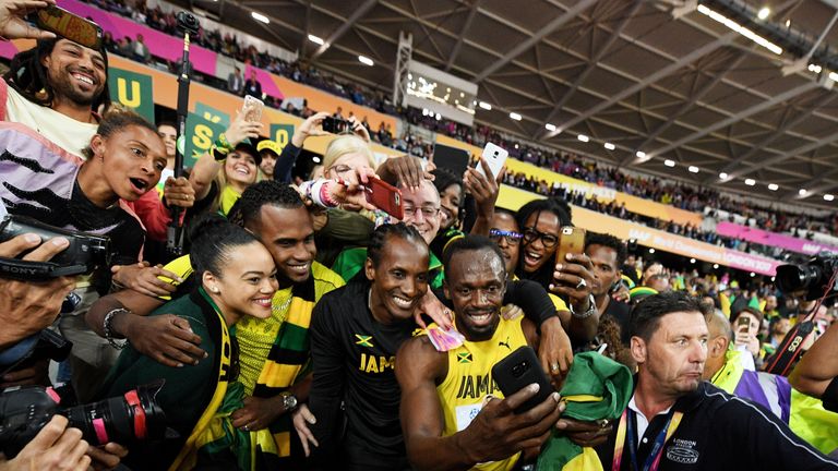 Bolt celebrates with Jamaica supporters after his defeat in the Olympic Stadium