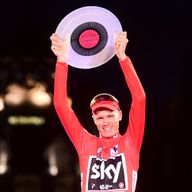 Chris Froome raises the trophy aloft in Madrid on Sunday night