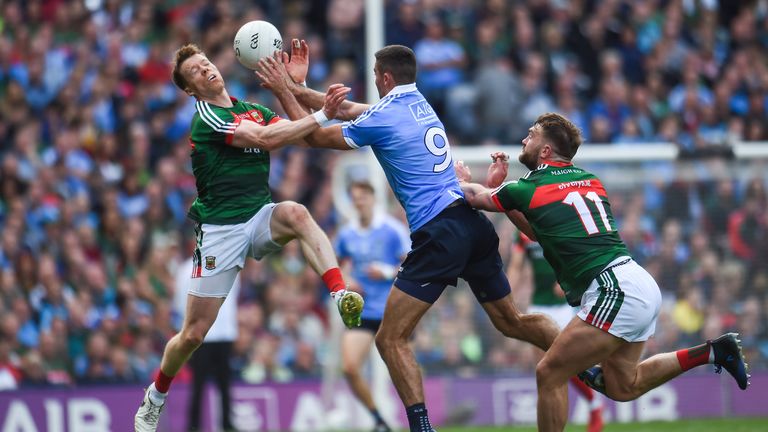 James McCarthy of Dublin in action against Donal Vaughan, left, and Aidan O'Shea of Mayo