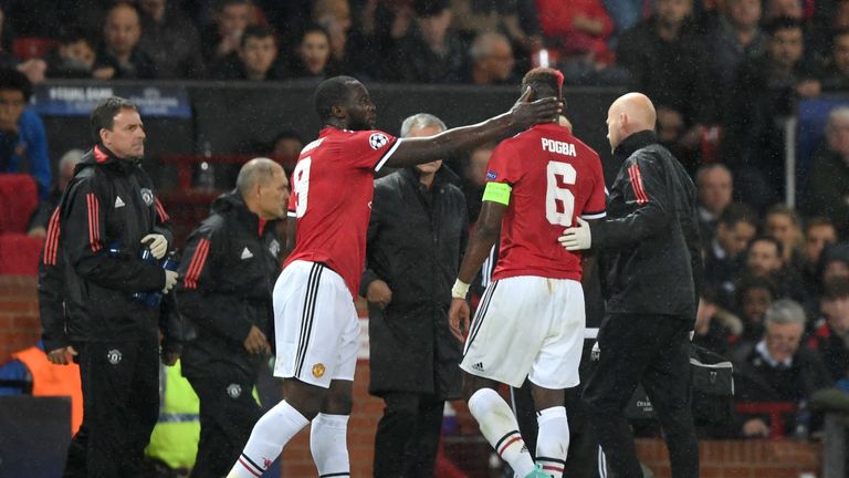 Romelu Lukaku embraces Pogba as he goes off