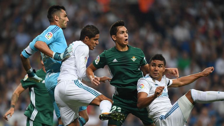 Real Madrid's Raphael Varane (second left) and Casemiro (right) vie with Real Betis' defender Aissa Mandi and Antonio Adan