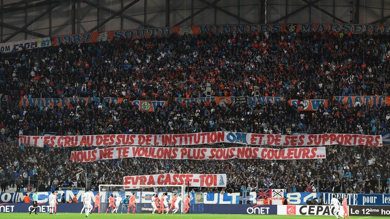 Olympique de Marseille fans hold a banner aimed at Evra, reading: 'You thought you were above the institution OM and its supporters. We don't want you wearing our colours.'