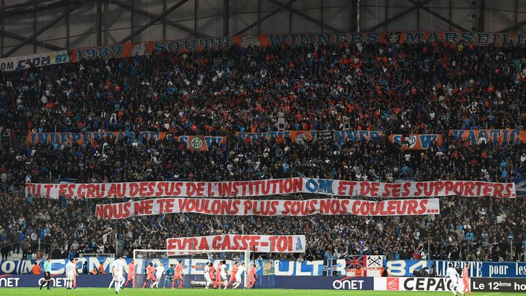 Olympique de Marseille fans hold a banner aimed at Evra, reading: 'You thought you were above the institution OM and its supporters. We don't want you wearing our colours'
