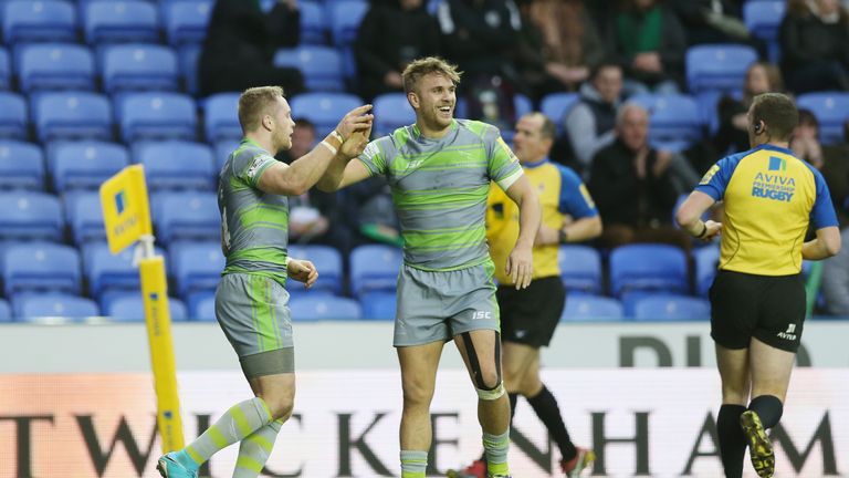 Alex Tait of Newcastle celebrates scoring a try against London Irish