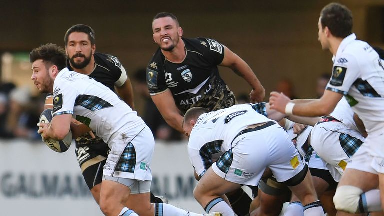 Glasgow scrum-half Ali Price (L) attempts to break through the Montpellier defence