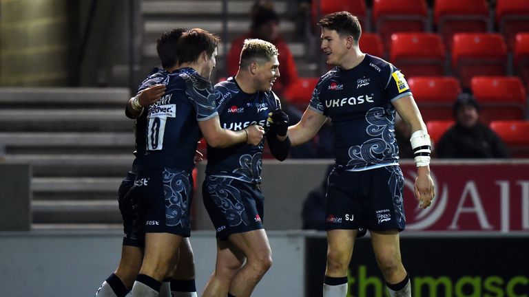 James O'Connor celebrates his try with team-mates