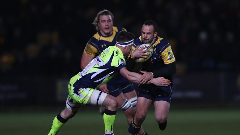 Jono Lance of Worcester is held up by Sale's Ben Curry