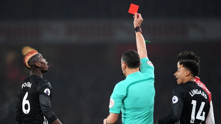 Paul Pogba is shown a red card by referee Andre Marriner for a dangerous tackle on Hector Bellerin