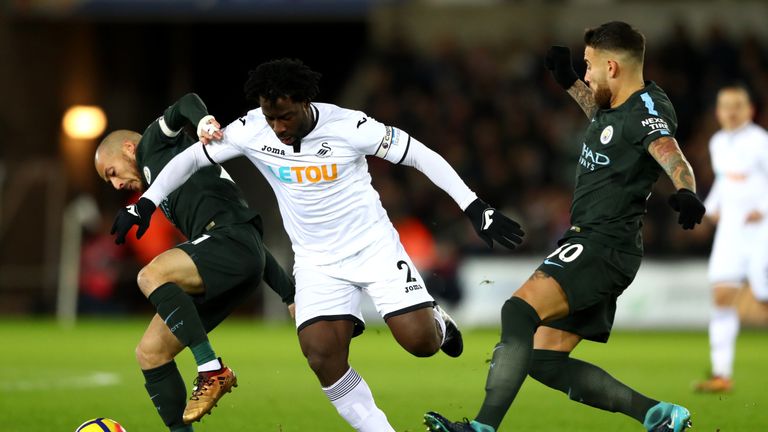 David Silva is challenged by Wilfried Bony