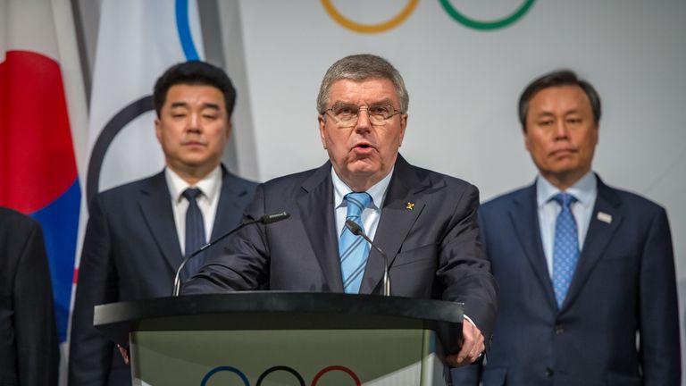 IOC President Thomas Bach confirms North Korea's participation at next month's Winter Olympic Games in Pyeongchang - flanked by officials from North and South Korea