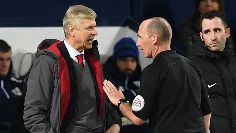 Arsene Wenger speaks to Mike Dean during Arsenal's game against West Brom
