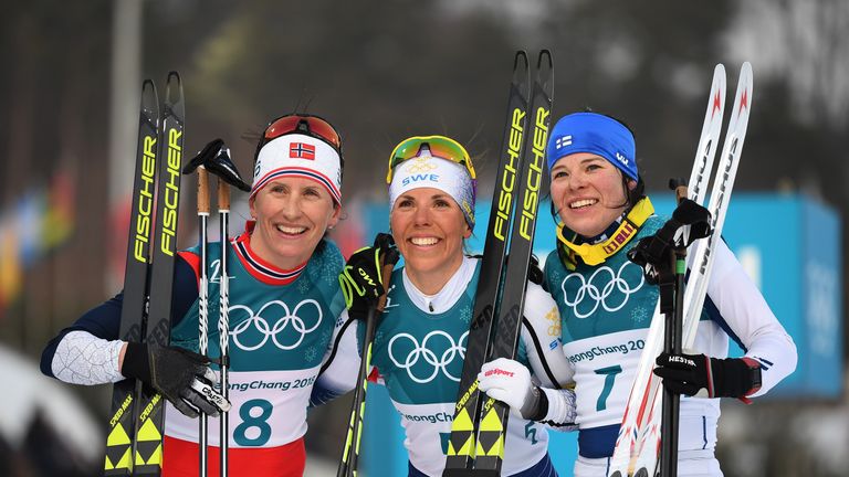 Silver medalist Bjoergen (left), gold medallist Kalla (middle)and bronze medallist Parmakowski