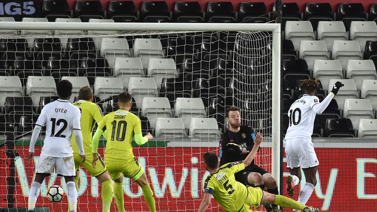 Abraham (right) scores Swansea's first goal at the Liberty