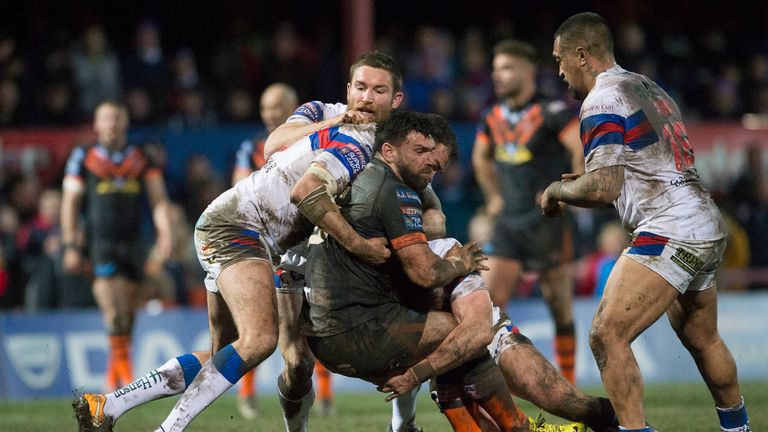 Castleford's Matt Cook is tackled by Wakefield's Anthony England and Tyler Randell