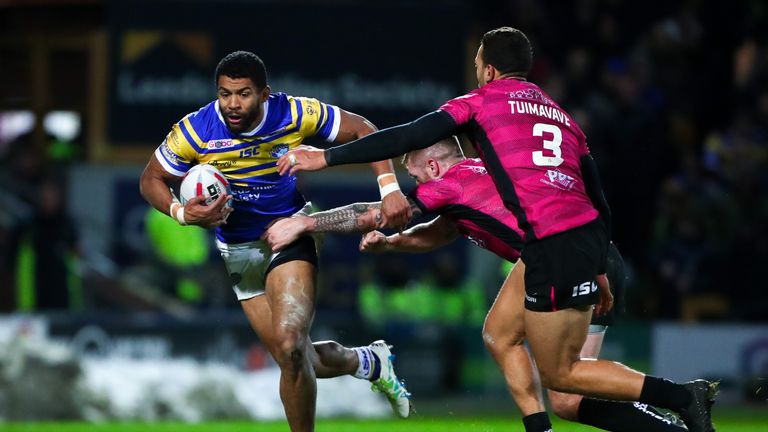 Leeds' Kallum Watkins is tackled by Hull FC's Marc Sneyd.