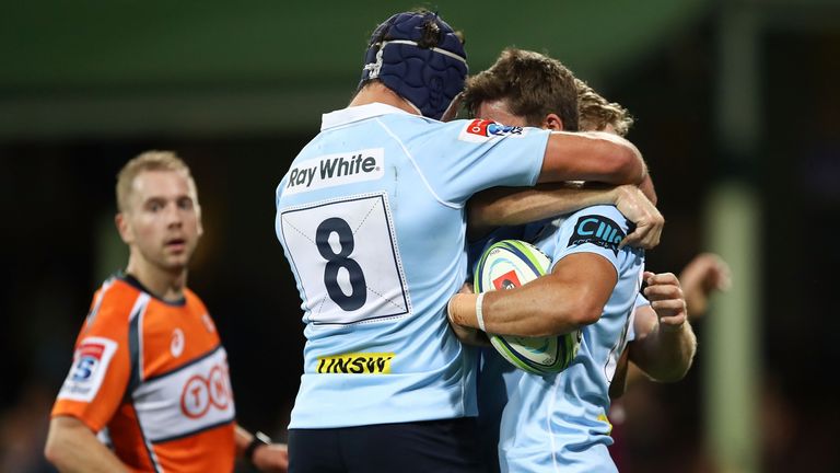Jake Gordon celebrates his Waratahs try during victory over the Reds in Sydney