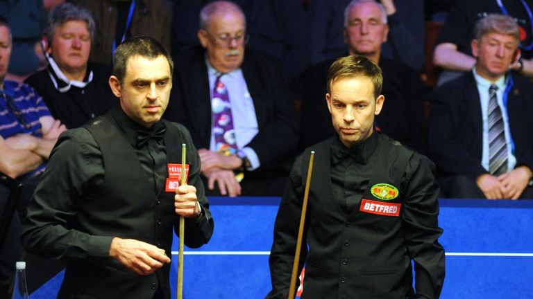 Ali Carter (right) is through to the quarter-finals of the World Snooker Championship after beating Ronnie O'Sullivan