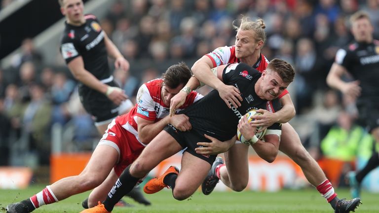 Henry Slade is tackled by Gloucester's Stuart Townsend and Mark Atkinson