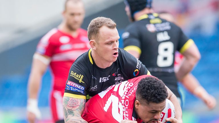 Warrington's Mike Cooper and Kevin brown tackle Salford's Derrell Olpherts