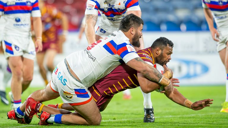 Wakefield's David Fifita is unable to prevent Huddersfield's Ukuma Ta'ai's from scoring