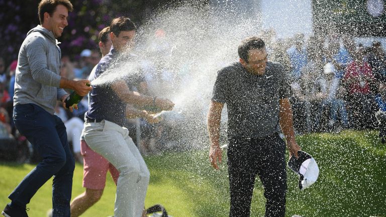 Molinari enjoys a champagne shower after completing victory