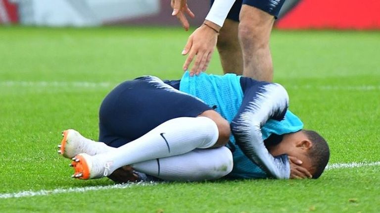 Kylian Mbappe goes down clutching his ankle in France training after Adil Rami challenge