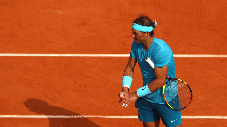 Nadal stretches his fingers after suffering from cramp