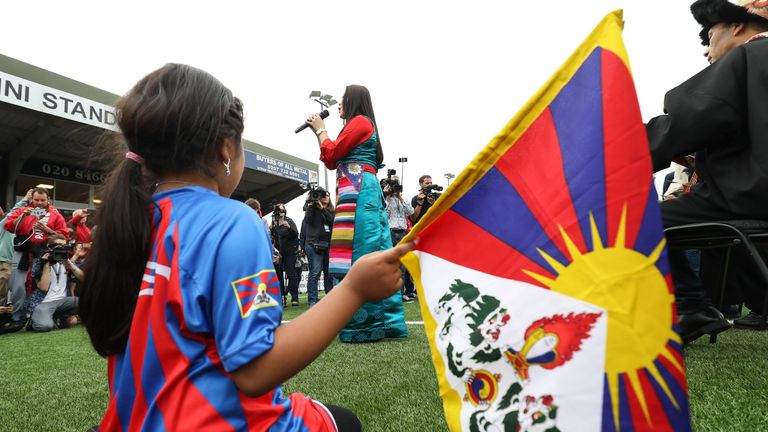 A young Tibet fan watches the opening ceremony
