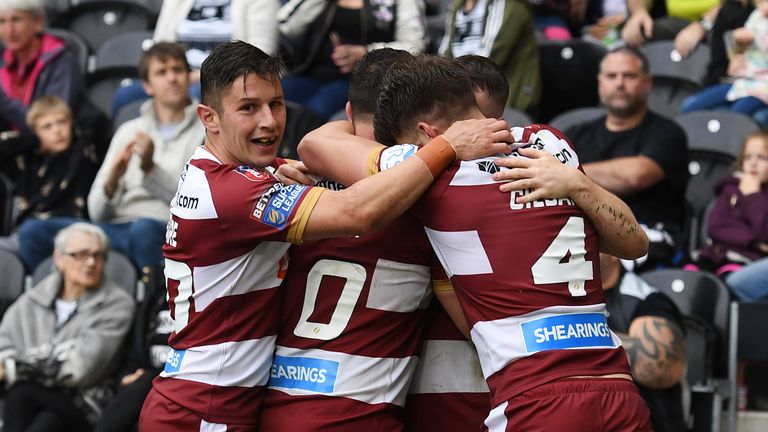 Wigan Warriors' Liam Marshall celebrates with team-mates after scoring a try