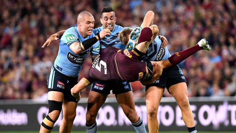 Corey Oates of Queensland is picked up in the tackle by Jake Trbojevic of the Blues