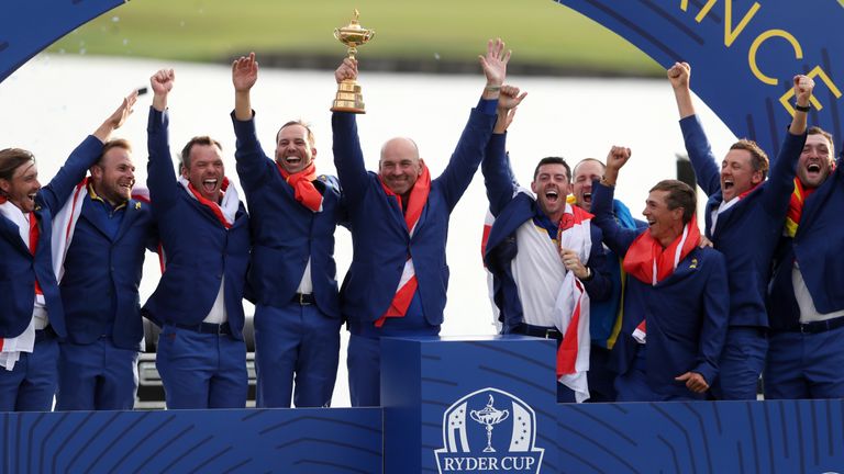 Thomas Bjorn lifts the Ryder Cup alongside his team