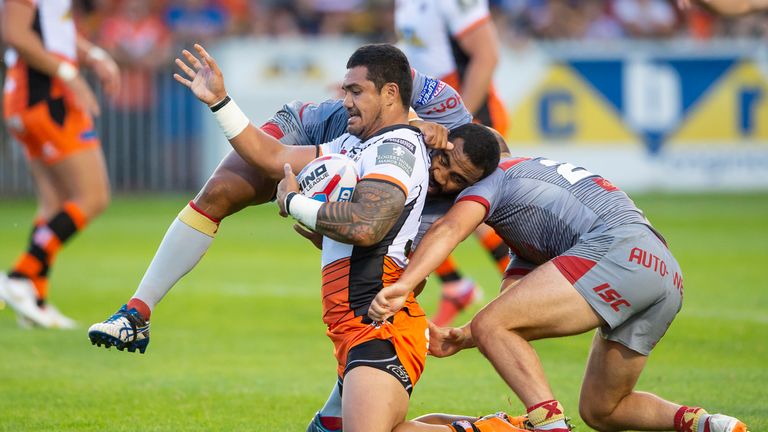 Castleford's Peter Matautia is tackled by Catalans Samisoni Langi & Benjamin Julien