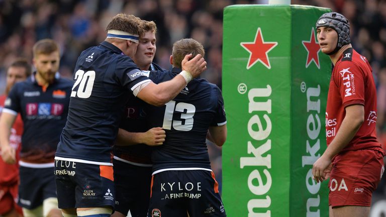 Chris Dean is swarmed by his Edinburgh team-mates after scoring at Murrayfield