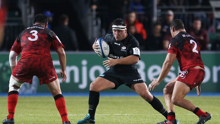 Jamie George of Saracens runs the ball at the Lyon defence