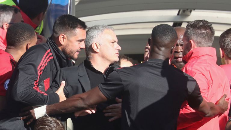 Jose Mourinho is held back after reacting after a fiery finish at Stamford Bridge