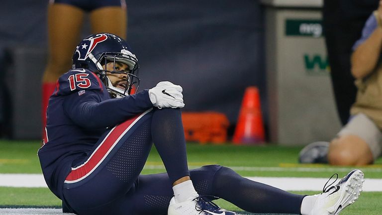 Will Fuller holds his right knee after landing hard on the turf