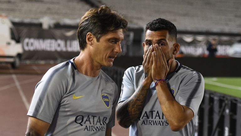 Carlos Tevez (right) and Boca Juniors coach Guillermo Barros Schelotto after the return leg postponed