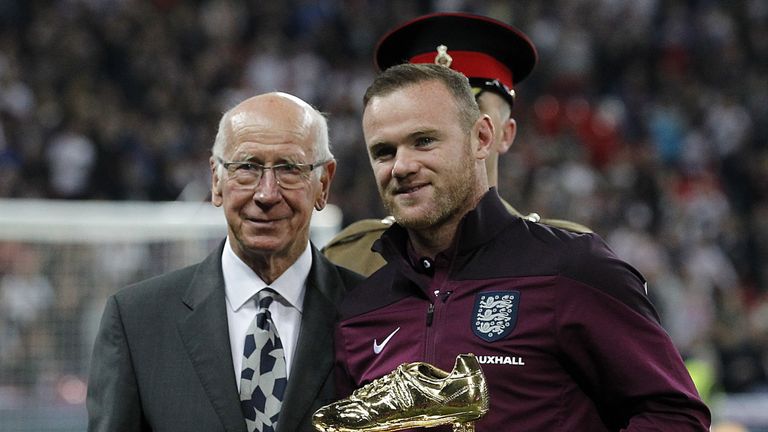 Sir Bobby Charlton hands Rooney his golden boot having broken his goalscoring record