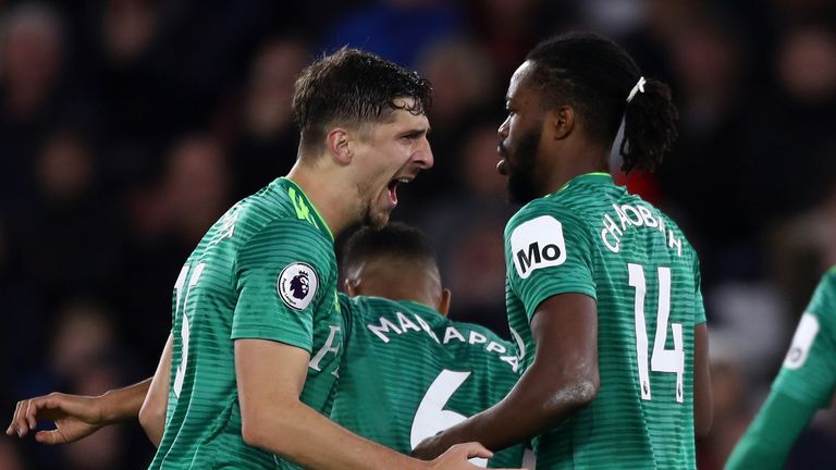 Watford's players celebrate their late equaliser at St Mary's