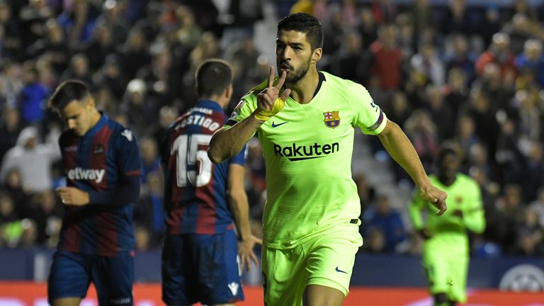 Luis Suarez celebrates breaking the deadlock for Barcelona on Sunday evening