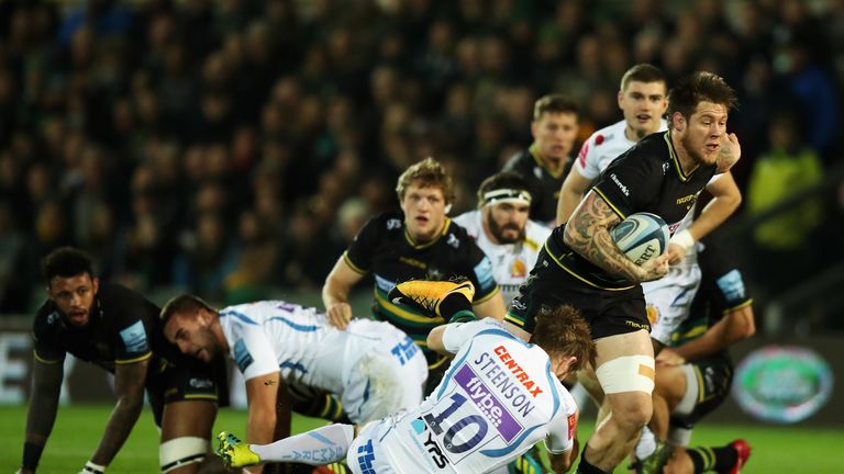 Teimana Harrison of Northampton Saints is tackled by Gareth Steenson 