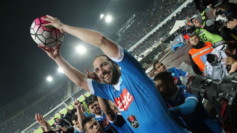 Higuain holds aloft the match ball which helped him break the Serie A goalscoring record