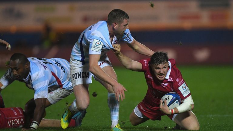 Finn Russell gets to grips with Scarlets wing Steff Evans