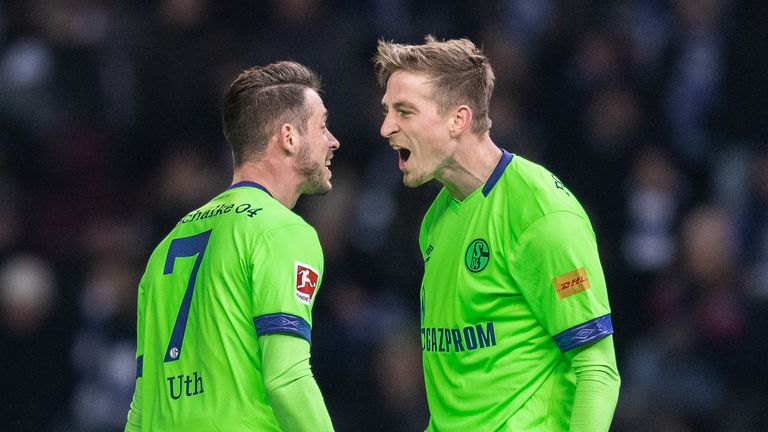 Schalke's Mark Uth (L) celebrates scoring with Bastian Oczipka
