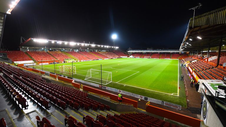 Two fans have been charged over allegations of racism at Pittodrie