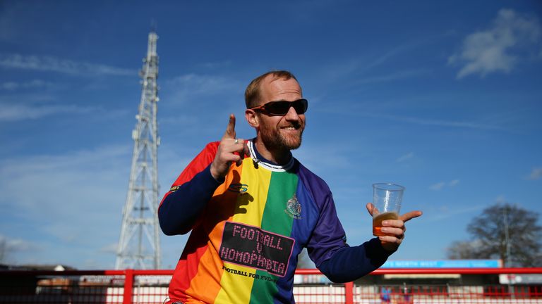 An Altrincham fan dons the multi-coloured Football v Homophobia shirt ahead of Saturday's match